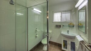 Glass shower and vanity in a Jumbuck Motor Inn bathroom