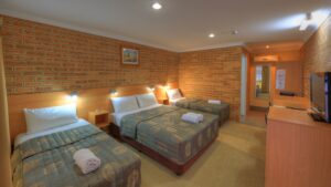 Family room with queen and single beds at the Jumbuck Motor Inn