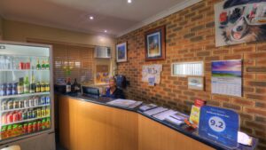 Reception desk and drinks fridge at the Jumbuck Motor Inn