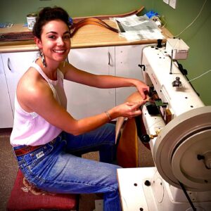 Leatherworker sewing at the machine in the Matilda Made Leather workshop