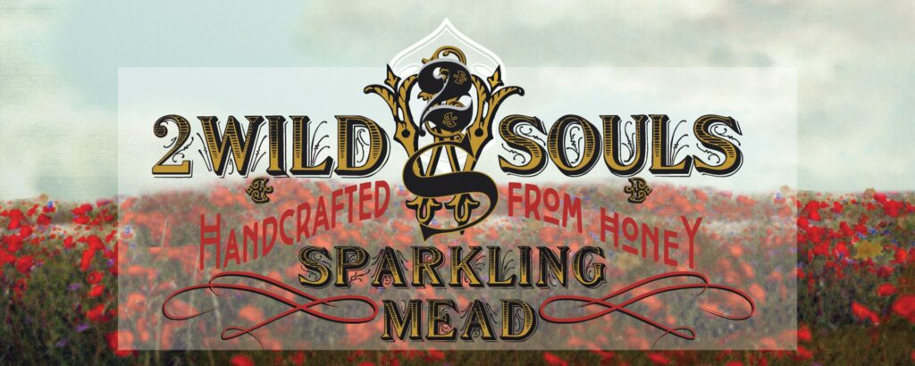 2 Wild Souls handcrafted sparkling mead sign over a field of red flowers