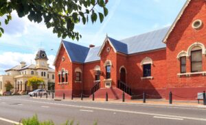 Street view of the red brick Sir Henry Parkes Memorial School of Arts on Rouse Street, Tenterfield