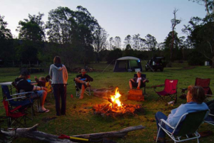 Campers around an evening fire at Levuka Rainforest Recreation Park