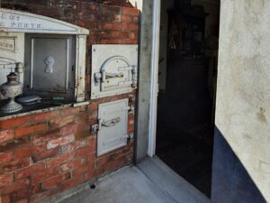 Brick fireplace and oven doors in the old kitchen at Centenary Cottage Museum