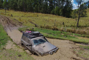 Four-wheel drive crossing a muddy track at Levuka Rainforest Recreation Park