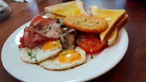 Cooked breakfast with bacon, eggs and toast at The Courtyard Cafe