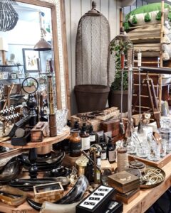 Table of silverware, clocks and collectables at Ruben & Flax