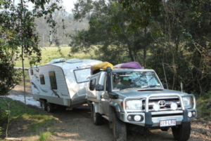 Caravan and four-wheel drive arriving through the forest at Levuka Rainforest Recreation Park