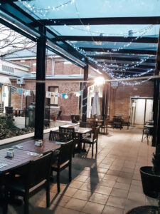 Fairy-lit courtyard dining area at The Courtyard Cafe