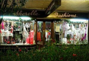 Sherelle Fashions window display lit up at night on Rouse Street