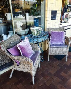 Cane armchairs with lilac velvet cushions at Ruben & Flax Homewares