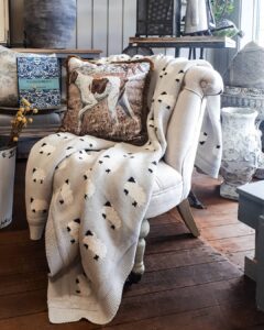 Armchair styled with hare cushion and star throw at Ruben & Flax