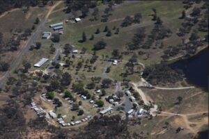 Aerial view of Glenlyon Dam Tourist Park campsites beside the water