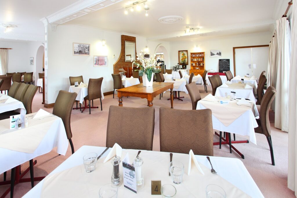 Dining room set with white tablecloths at Henry's On Rouse Restaurant
