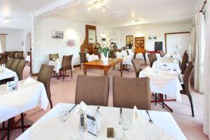 Dining room set with white tablecloths at Henry's On Rouse Restaurant