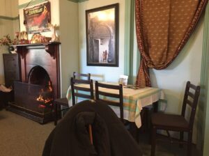 Table by the fireplace inside The Bohemian Tearoom