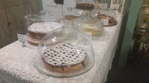 Cake table with lace cloth and covered stands at The Bohemian Tearoom