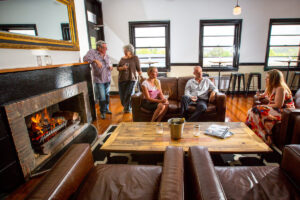 Guests relaxing by the fireplace lounge at The Commercial Boutique Hotel