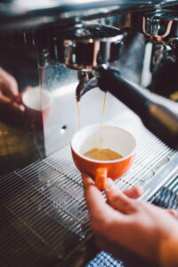 Barista pouring espresso at The Commercial Boutique Hotel cafe