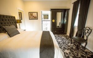 Deluxe king room with upholstered bedhead at The Commercial Boutique Hotel