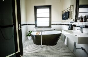 Freestanding black bath in the monochrome ensuite at The Commercial Boutique Hotel