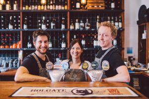 Bar staff pouring craft beers behind the bar at The Commercial Boutique Hotel