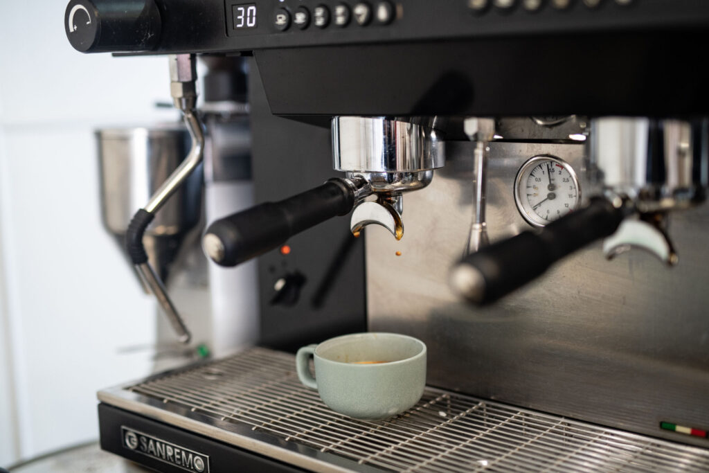 Espresso machine pouring coffee at The Artisans Altitude