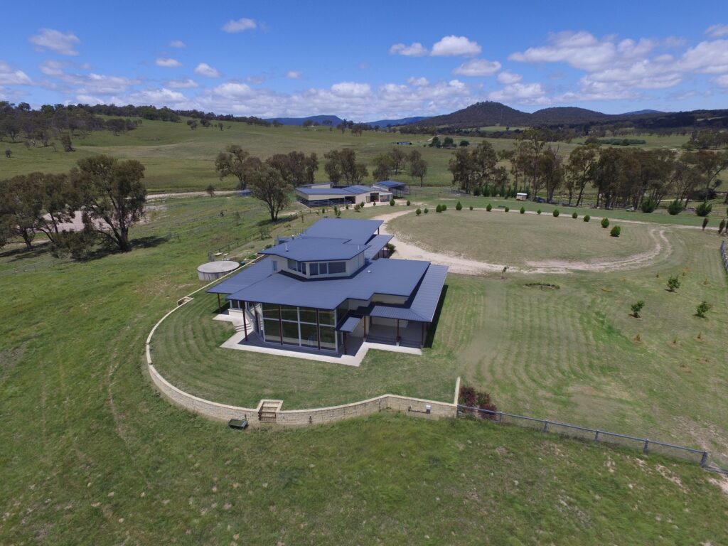 Aerial view of the Donegal Farmstay homestead, arena and paddocks