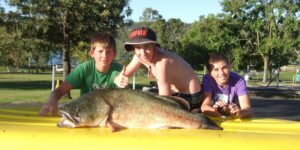 Two anglers posing with a large Murray cod at Glenlyon Dam Tourist Park