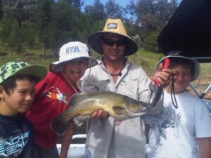 Father and kids showing off a big Murray cod caught at Glenlyon Dam