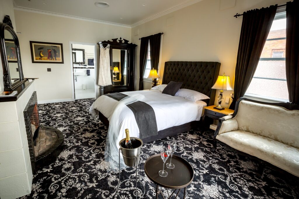 Boutique suite with black and white decor and champagne on ice at The Commercial Boutique Hotel