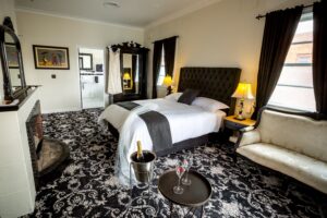 Boutique suite with black and white decor and champagne on ice at The Commercial Boutique Hotel