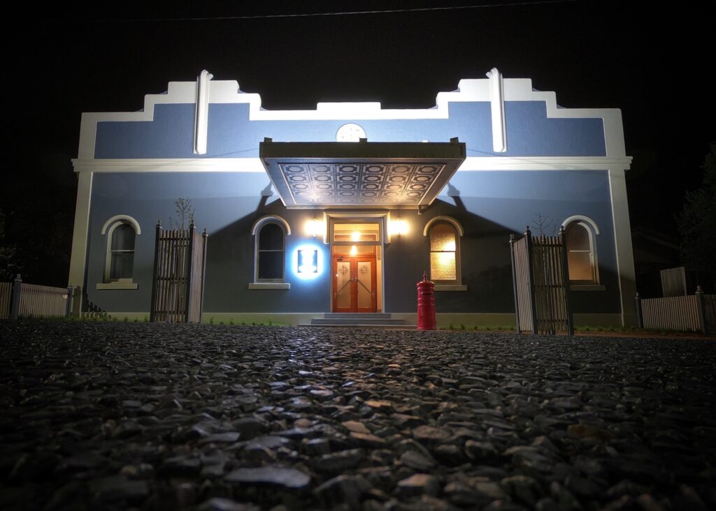 The Old Council Chambers art deco facade lit up at night, Tenterfield
