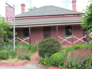 Front verandah and gardens of the historic Henry's Cottage B&B
