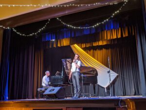 Pianist and singer performing on stage at the Tenterfield Cinema and Theatre