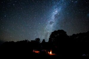 Campfire under a starry night sky and the Milky Way at Cullendore High Country