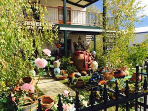 Garden courtyard filled with pots, statues and curios at Margot Rees Antiques