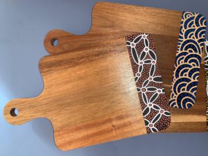 Timber serving boards with Aboriginal fabric wraps at Gallery 299