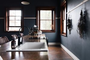 Freestanding bath beside a timber-framed window in the Old Council Chambers suite