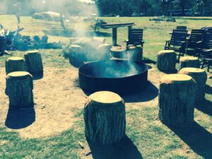 Fire pit ring with log stools at Kookaburra Camping and Caravan Park