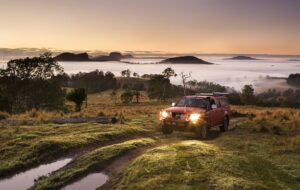 Four-wheel drive crossing misty high country at sunrise at Levuka Rainforest Recreation Park