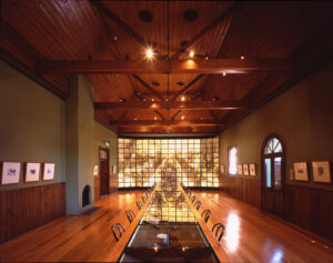 Timber-lined exhibition hall with glass brick wall at the Sir Henry Parkes Memorial School of Arts