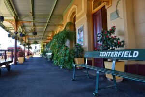 Tenterfield Railway Museum platform with station sign, benches and flowers