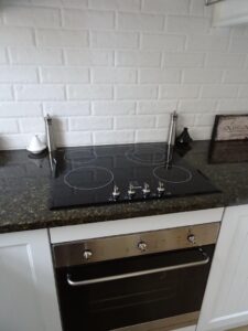 Ceramic cooktop and wall oven in the Red Rose Cottage kitchen