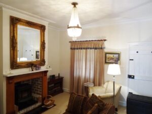 Gilt mirror over the fireplace in the Red Rose Cottage lounge