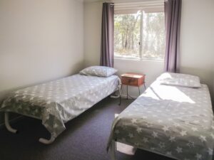 Twin single beds in the second bedroom at Robinsons Cabin