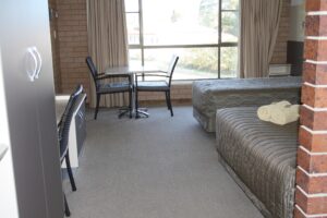 Guest room with desk and garden window at the Tenterfield Motor Inn