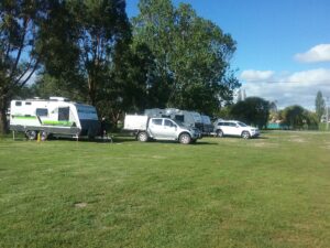 Caravans set up on the green camping area at Tenterfield Showground