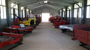 Collection of railway trikes and trolleys displayed in a shed at Tenterfield Railway Museum