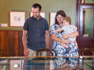 Young family looking at exhibits in the Sir Henry Parkes Memorial School of Arts museum